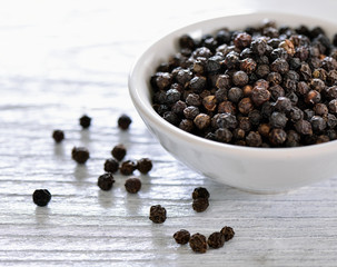 black pepper in bowl on white background