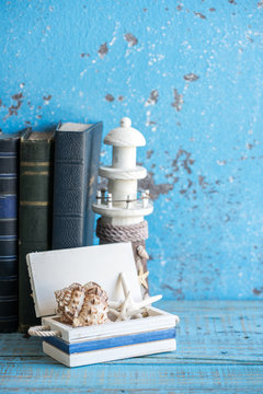 Decorative photo and marine items on wooden background.