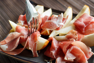 Appetizer with pear and italian parma ham