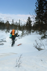 Fototapeta na wymiar Tourist in Russian Lapland crossing unfrozen river, Kola Peninsula
