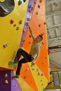 Man Climbing Up On Practice Wall