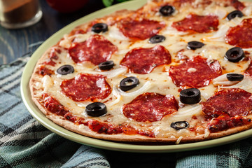 Pizza pepperoni with olives served