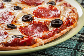 Pizza pepperoni with olives served
