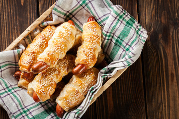 Rolled hot dog sausages baked in puff pastry