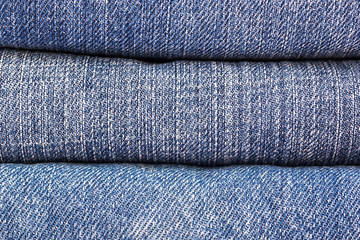 lot of denim blue jean texture is the classic indigo fashion. close-up of denim blue jeans, concept for fashion