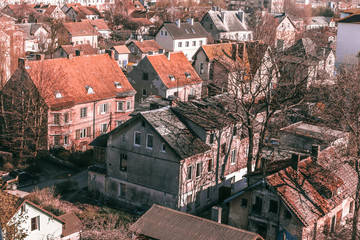 Fototapeta na wymiar urban texture background of red tiled roofs of houses in old city in Europe, view of vintage houses with tile roofs in old town.