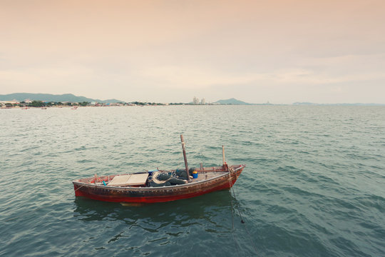 Old fishing boat on the sea coast of Thailand.