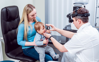 Indirect ophthalmoscope. Retinal examination. Fundoscopy. Child vision test.