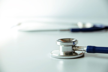 Stethoscope and medical equipment on light background with copy space