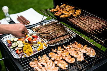 Barbecue grill party. Tasty Fresh food. Shrimps  spit and Beef rolls with bio young spices, chicken strips. bio vegetables