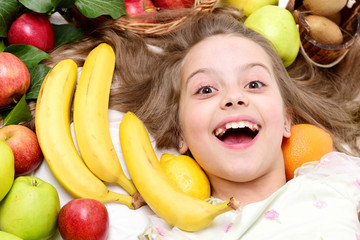 Fototapeta na wymiar exotic fruit or summer background with small happy girl