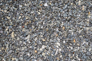 Background of small gravel of different colors - gray, yellow and light. Placer of rubble