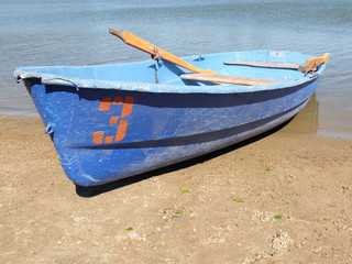 Boat on the sandy shore of the lake