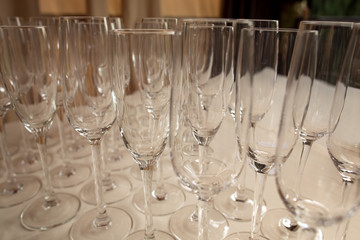 Rows of empty glasses for champagne, wine and other alcoholic drinks
