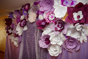 Violet paper flowers on wedding arch, colorful decoration for wedding ceremony