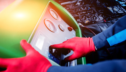 Servicing car air conditioner. Service station.
