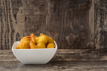 Deep fried shrimps in a bowl on wooden background    