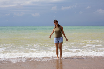 Beautiful girl in a t-shirt on the beach. Recreation
