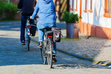 bicycle riders in a village