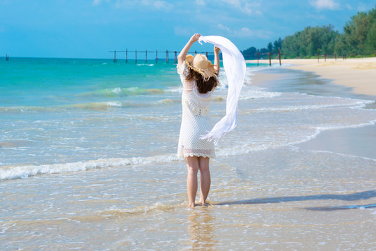 Woman is enjoy walking and sightseeing on the beach during summer time.