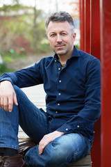 Obraz premium Portrait of handsome man posing in spring Japanese garden