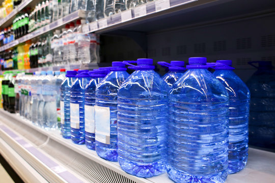 Bottles Of Water On Shelf At Supermarket