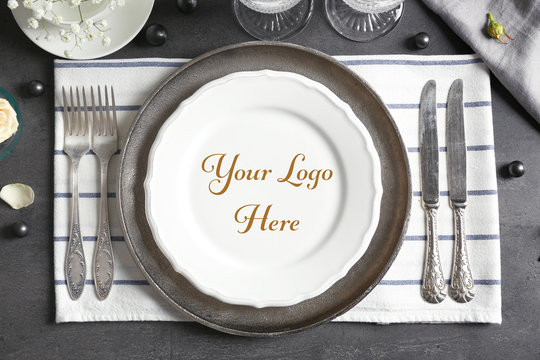 Elegant table setting with space for logo on grey background