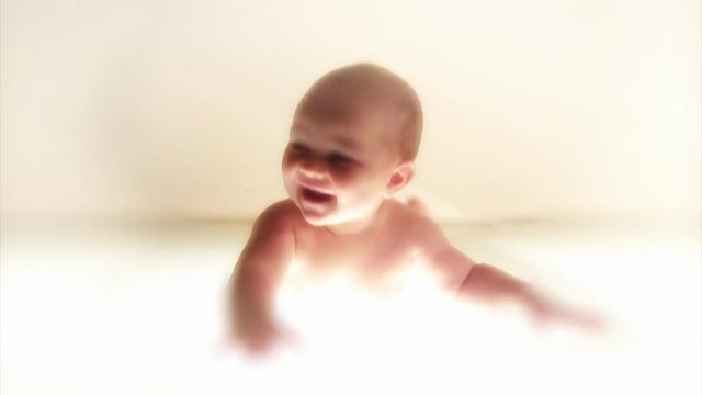 Infant laughing. White background.
