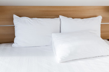 Fototapeta na wymiar White pillows lay on wide empty bed