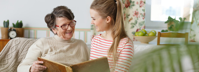 Grandma and granddaughter watching photo album