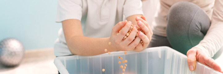Boy exercising with physiotherapist © Photographee.eu