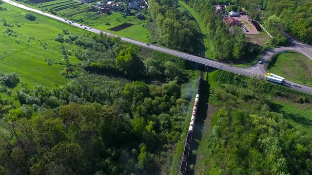 locomotive moves with empty containers near village