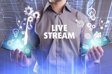 Business, Technology, Internet and network concept. Young businessman working on a virtual screen of the future and sees the inscription: Live stream