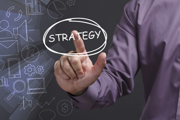 Business, Technology, Internet and network concept. Young businessman shows the word: Strategy