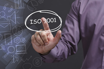 Business, Technology, Internet and network concept. Young businessman shows the word: ISO 9001