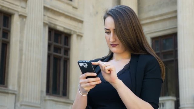 Happy young woman taking a photo of herself and posting it on social media