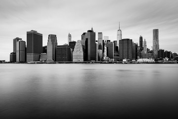 Manhattan downtown skyline in cloudy day, black and white colors, New York, USA