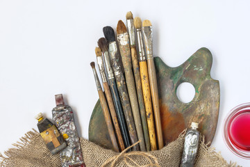 Brushes, palette, tubes with paint and solvent