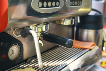 prepares espresso in his coffee shop; close-up