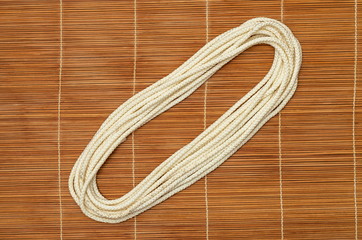 Folded rope, on a wooden background