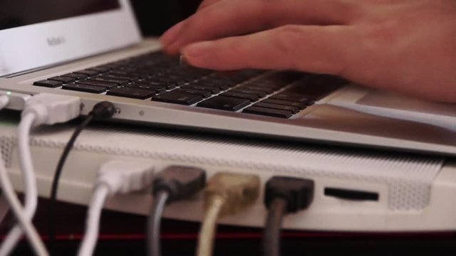 Computer Literate Operator,NoteBook Keyboard,side of macbook pro laptop showing USB and power conections.