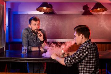 Vaping man holding a mod. A cloud of vapor at the vapebar.