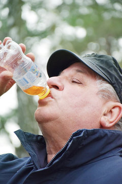 Mature Man Drinking Fizzy Water 