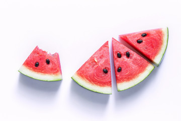 Watermelon sliced into a slice of wood on an white background.