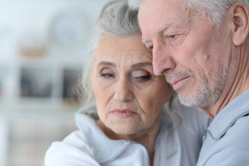 Beautiful sad elderly couple