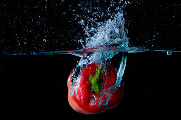 Red Bell Sweet Pepper Droped Into Water