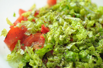 Spring vegan salad with tomato, cucumbers, radish and chinese cabbage