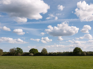 a walking path through an open countryside in the heartland of constable country essex england in the uk with no people and a clear sky on a summer afternoon