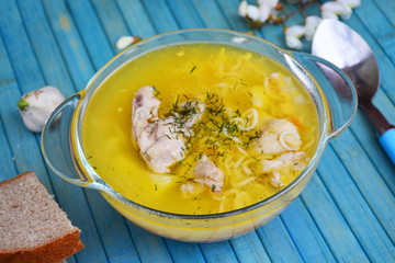 Soup with chicken meat on a blue background
