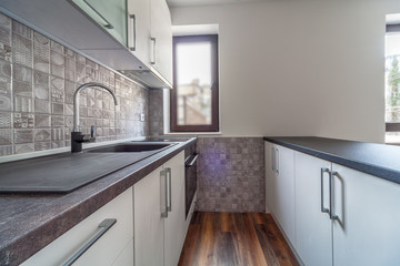 New modern and empty white kitchen. New home. Interior photography. Wooden floor.